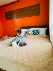 a bedroom with a bed with an orange wall at CONDO unit in Puerto Princesa Palawan in Puerto Princesa City