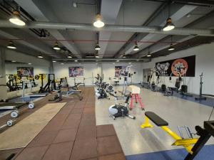 a gym with a lot of treadmills and exercise equipment at Arena Hotel Goranboy in Goranboy