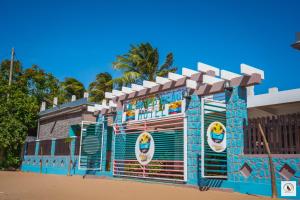 a building on the beach with a blue at Palmares Beach Hotel in Andjamen