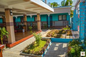 a house with a garden in front of it at Palmares Beach Hotel in Andjamen