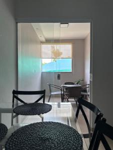 a room with chairs and a table and a window at The Wall in Araçatuba
