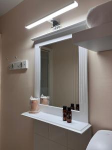 a bathroom with a mirror and a white sink at Chambres D'Hôtes Le Domaine de la Marnière in Villainville