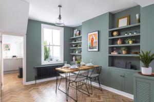 a dining room with blue walls and a table and chairs at Queens Gardens in Brighton & Hove +36 photos