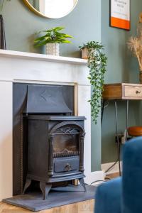 a black fireplace in a living room with a mirror at Queens Gardens in Brighton & Hove