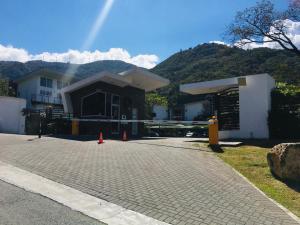 a house being constructed with orange cones in front of it at Brisa de rio Apartamento in La Chimba