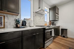 a large kitchen with black cabinets and a window at Snowbasin Retreat in Roam RO 5966 Wkly Disc in Mountain Green