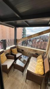a balcony with chairs and couches on a building at Hotel Premium in Pristina