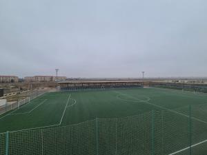 an empty soccer field with a soccer goal at Arena Hotel Goranboy in Goranboy