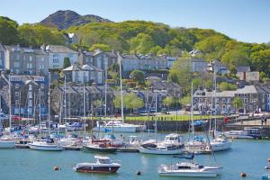 a bunch of boats are docked in a harbor at Garth Cottage in Porthmadog