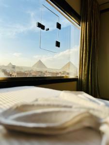 Voodi või voodid majutusasutuse Pyramids Heart Hotel toas