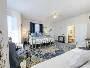 a bedroom with a bed and a living room at Victorian Inn Bed And Breakfast in Marblehead