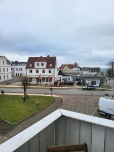 a white van is parked on a street with buildings at Central apartment in Sassnitz Crampas 3 in Sassnitz
