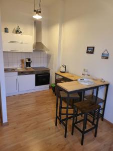 a kitchen with a table and chairs in a room at Central apartment in Sassnitz Crampas 3 in Sassnitz