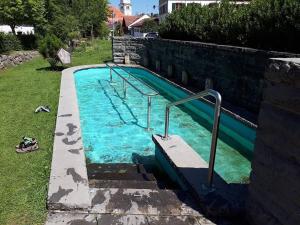 a swimming pool with a slide in a yard at Alpen Hotel Martin in Nesselwang