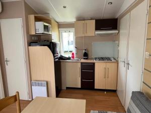 a small kitchen with a sink and a stove at Mobil home in Angles