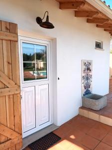 a door to a patio with a window at Casa do Moinho Rural Retreat in Podentes