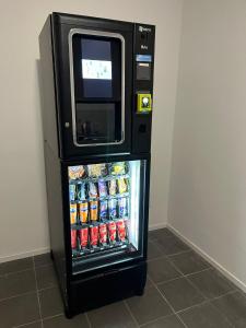 a refrigerator with a microwave on top of it at Charleville C centre - gare - aéroport in Charleroi
