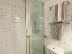 a bathroom with a shower with a glass door at Fferm Porthdafarch South Farm House in Holyhead +34 photos
