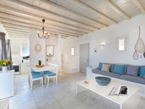 a living room with a couch and a table at The Mykonian Sunset Villas - 10min from Town in Agios Ioannis Mykonos