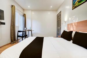 Postel nebo postele na pokoji v ubytování Super Hotel O Britania Chowk