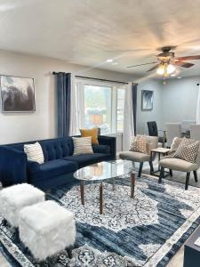 Una sala de estar con un sofá azul y sillas. en Family-friendly Decatur Oasis, en Decatur