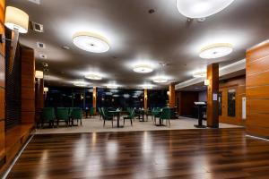 a dining room with green chairs and tables at Hotel Alhar in Lubliniec +93 photos