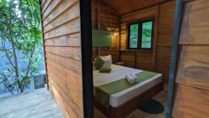 a room with a bed in a wooden house at Soul Villas & Cabana Near Beach with Pool in Tangalle +164 photos