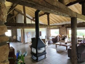 a living room with a wood stove in it at Caserio EL AJO in Herrán