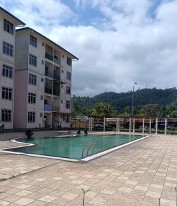 a swimming pool in front of a building at Bentong homestay in Bentong