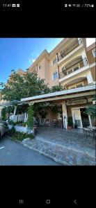 a large building with a car parked in front of it at Studio Anelia in Sveti Vlas