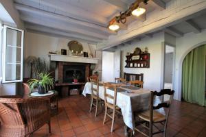 a dining room with a table and chairs and a fireplace at Pinchat in Labastide-Clairence