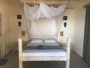 A bed or beds in a room at Black Marlin - Kadidiri