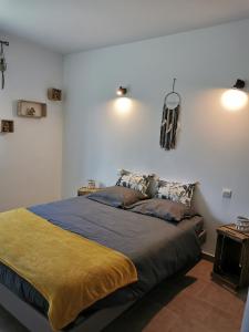 a bedroom with a large bed in a room at La Maison De Titou in Lazer +9 photos