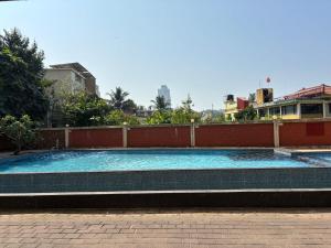 a large swimming pool in the middle of a building at Spacious 3BHK for a Perfect Stay in Mangalore
