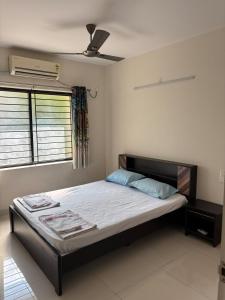 a bedroom with a bed with a ceiling fan at Spacious 3BHK for a Perfect Stay in Mangalore +32 photos