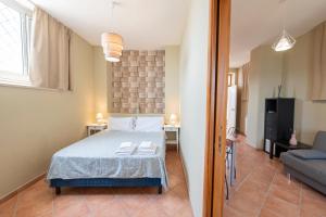 a bedroom with a bed and a living room at Artis Mare in Pozzuoli