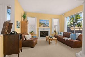 a living room with a couch and a fireplace at Encinitas Retreat Private Pool and Spa Short Drive to Beach in Encinitas +32 photos