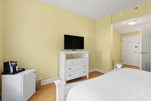 a bedroom with a bed and a tv on a dresser at Oakwood Resort in Syracuse