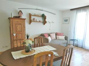 a living room with a table and a couch at Onyx by Fewotessin in Locarno