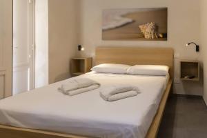 Postel nebo postele na pokoji v ubytování Mariù Loft & Apartments