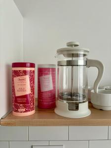 a kitchen counter with a blender on a wooden shelf at Śląska 33 in Gdynia
