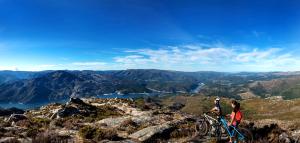 two people riding bikes on top of a mountain at Lobios Caldaria Hotel Balneario in Bubaces