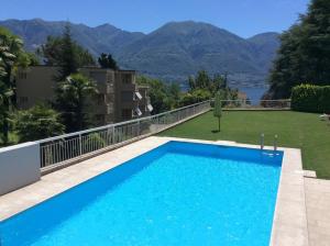 a swimming pool on the roof of a house at Bellavista by Fewotessin in Locarno