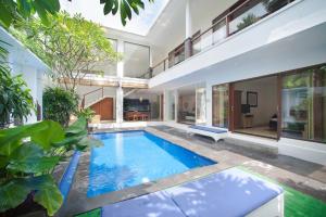 an indoor swimming pool in the middle of a house at Villa Penelopy in Seminyak