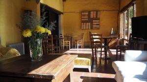 a living room with a vase of flowers on a table at Rincón De Fuego in Tilcara
