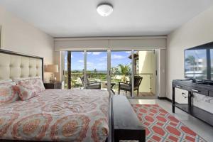 a bedroom with a large bed and a balcony at Beachfront - Eagle Beach - Sapphire 2BR condo E322 in Palm-Eagle Beach +51 photos
