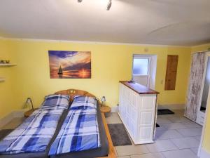 a small bedroom with two beds and a dresser at Ferienwohnung Ackermann in Ribnitz-Damgarten