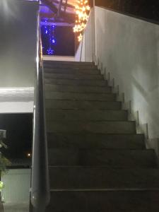 a set of stairs leading up to a building at night at Recanto do Peró in Cabo Frio