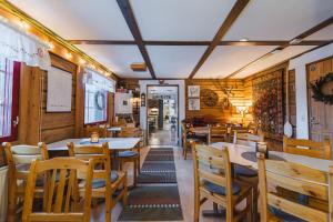 a restaurant with tables and chairs in a room at Lodge 67°N Lapland in Äkäslompolo