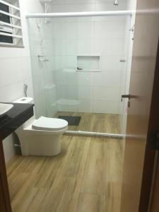 a bathroom with a toilet and a sink and a shower at Recanto do Peró in Cabo Frio +9 photos